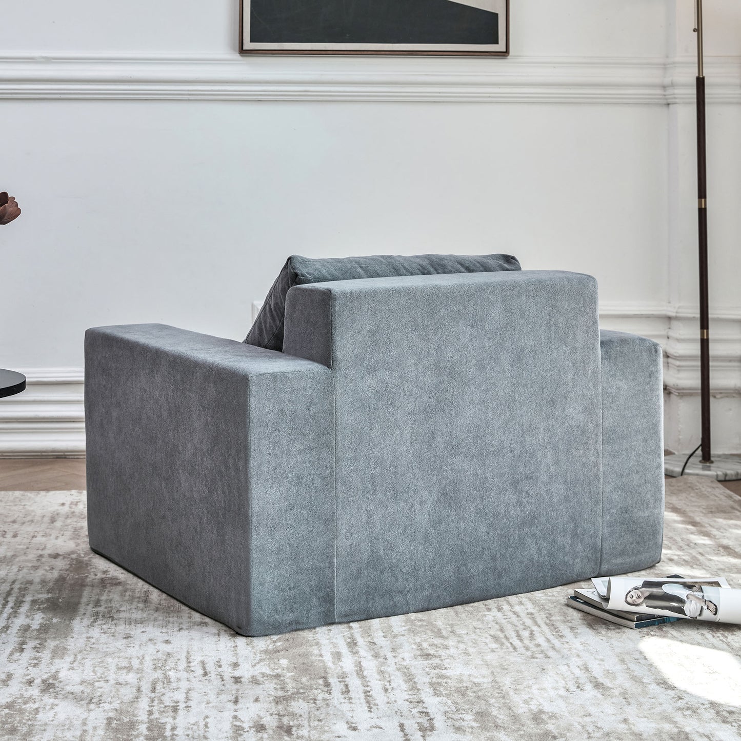 Plush grey fabric armchair with clean modern lines ideal for a contemporary living space