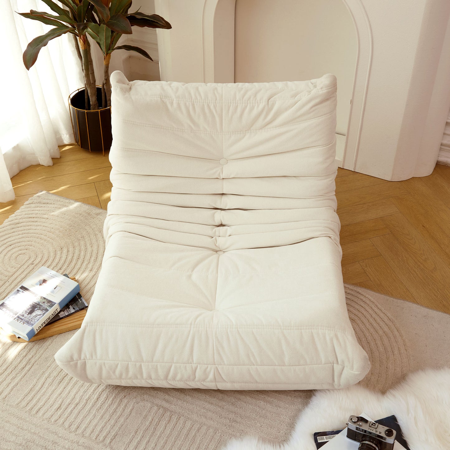 Cream tufted floor sofa with soft fabric upholstery perfect for lounge seating
