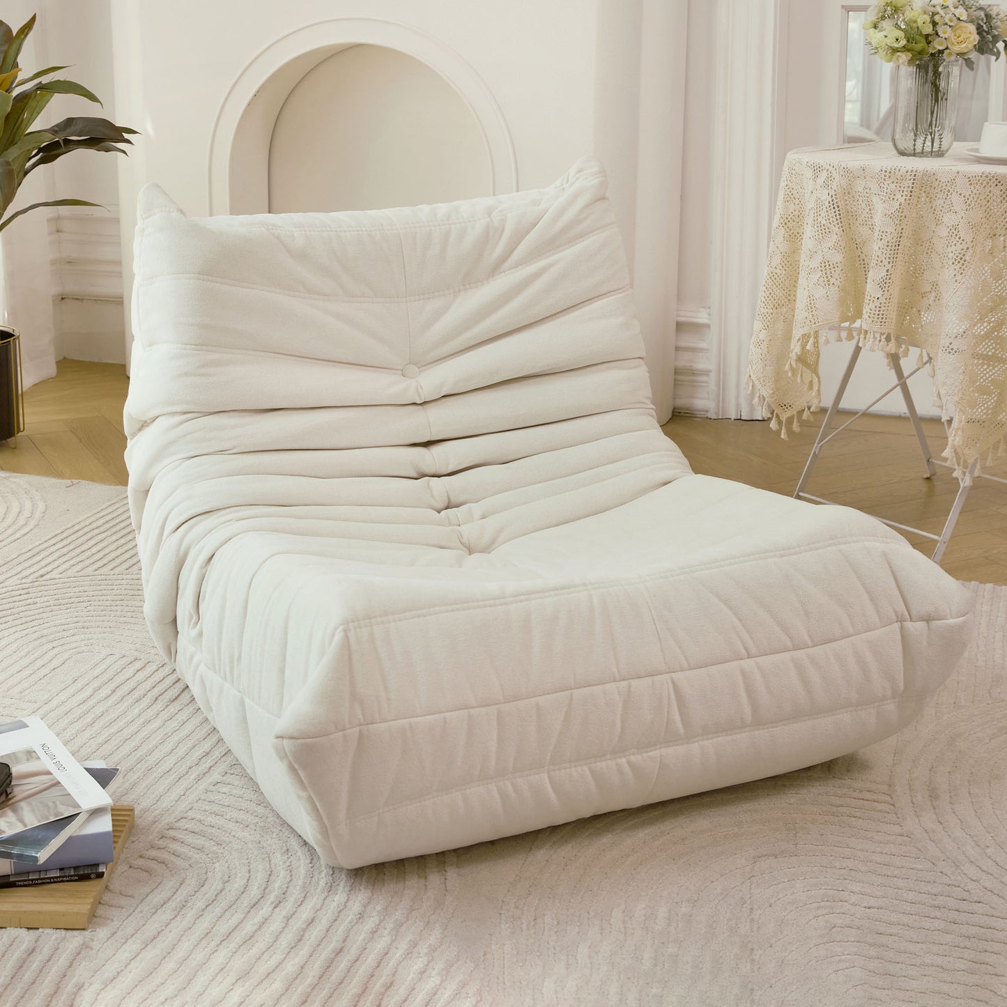 Cream tufted boucle lounge chair with plush cushioning and rounded back