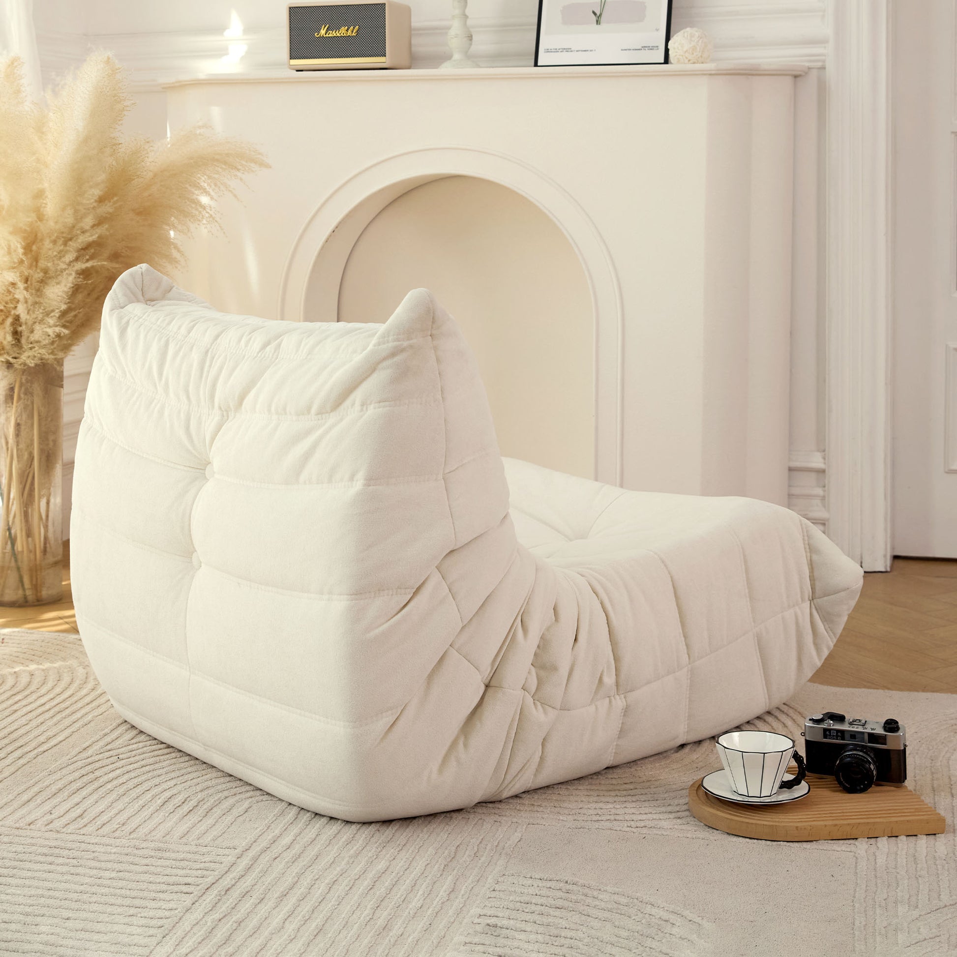 Plush creamcolored bean bag chair with quilted detailing perfect for cozy relaxation