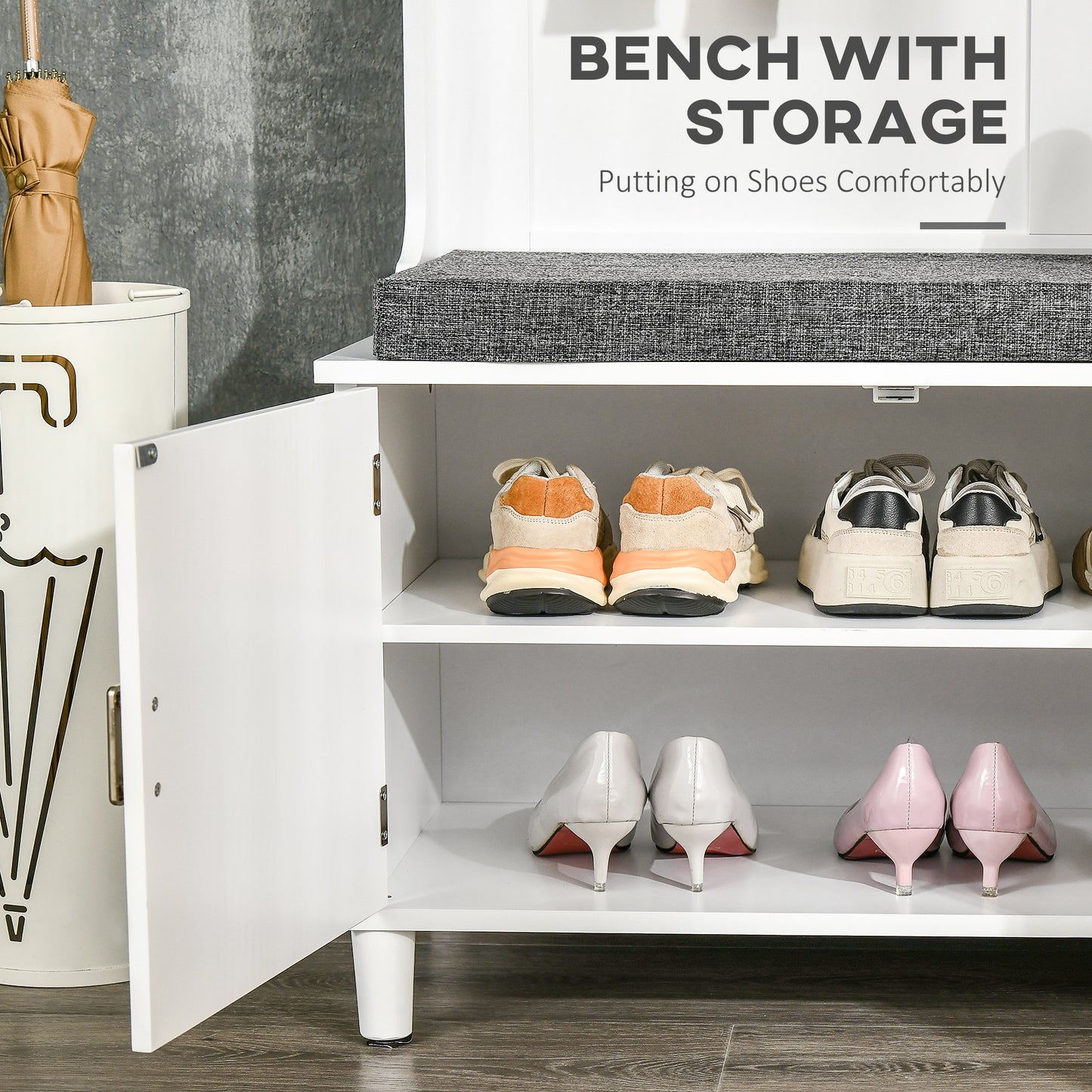 White entryway bench with gray upholstered seat and shoe storage compartments