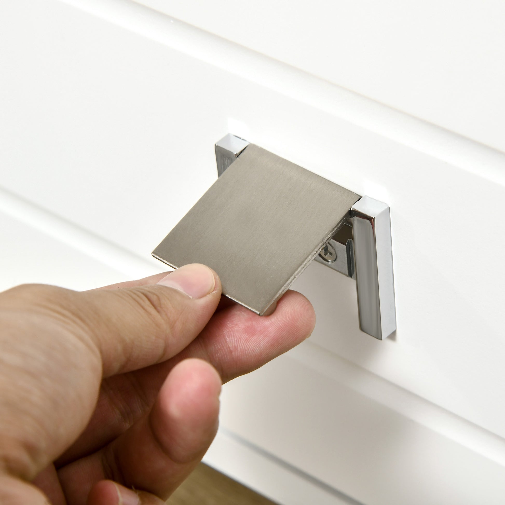 Brushed nickel cabinet pull with a modern minimalist design and chrome accents