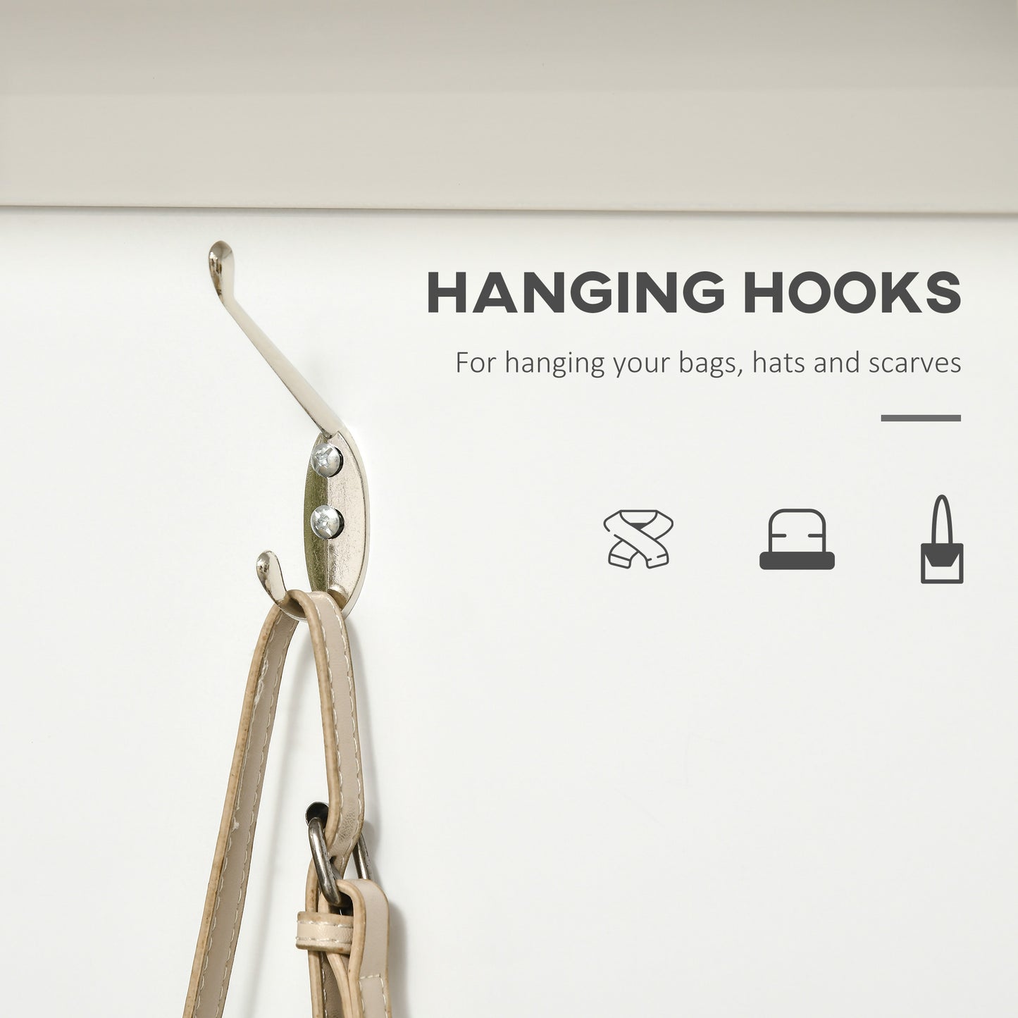 Silver wall hook holding a tan purse strap