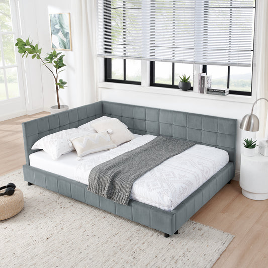 Grey velvet tufted sectional daybed with white bedding and decorative pillows