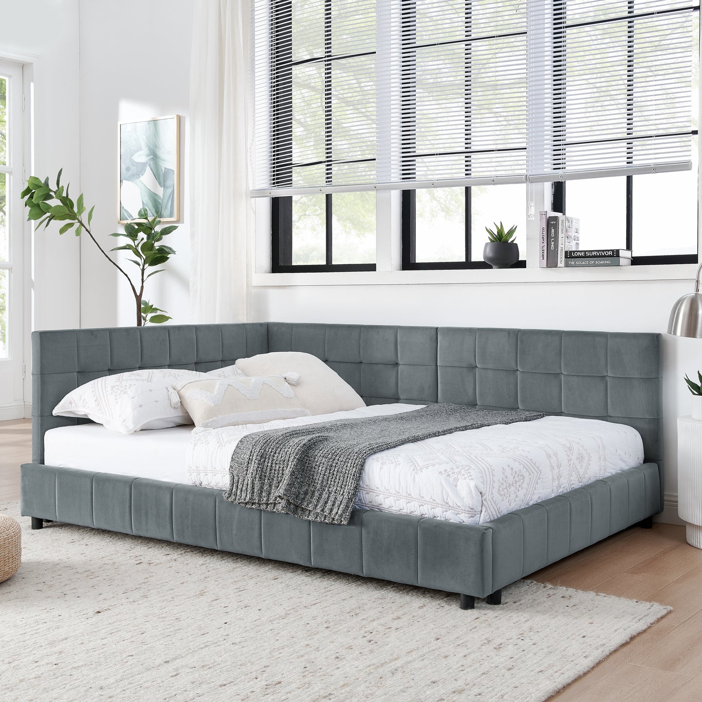 Grey velvet corner daybed with tufted headboard and upholstered frame