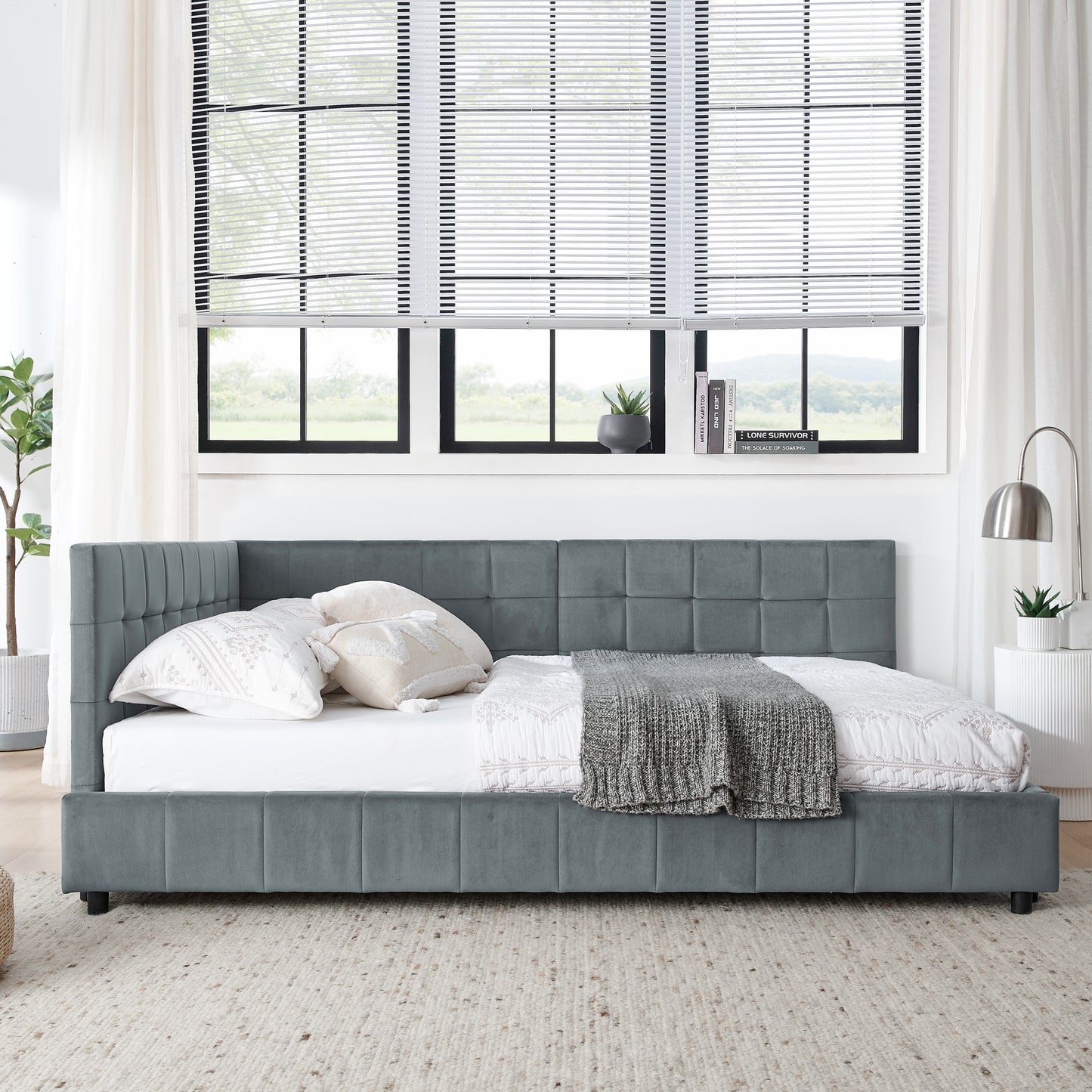 Gray velvet daybed with tufted headboard and pillows