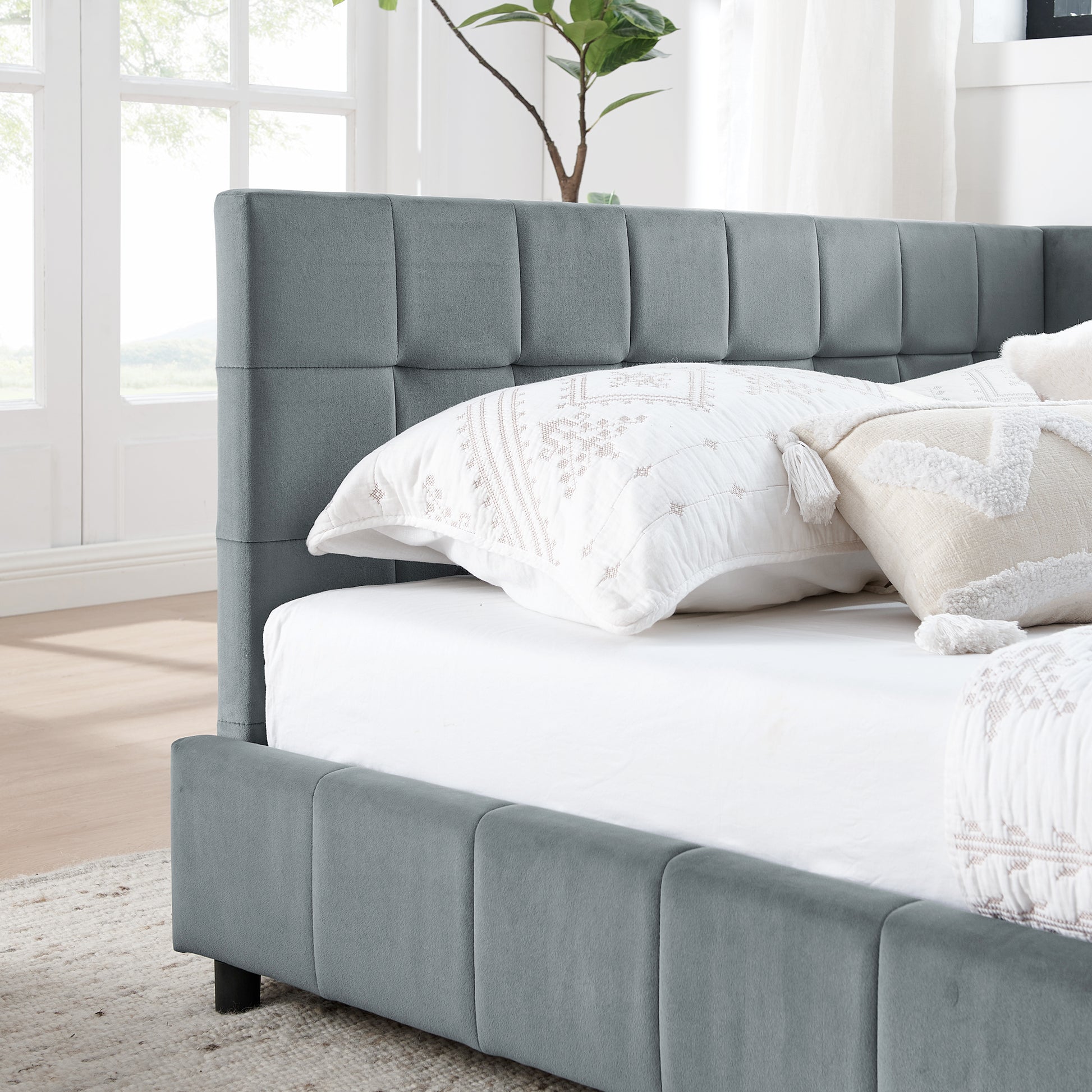 Grey velvet channel tufted bed frame with white linens
