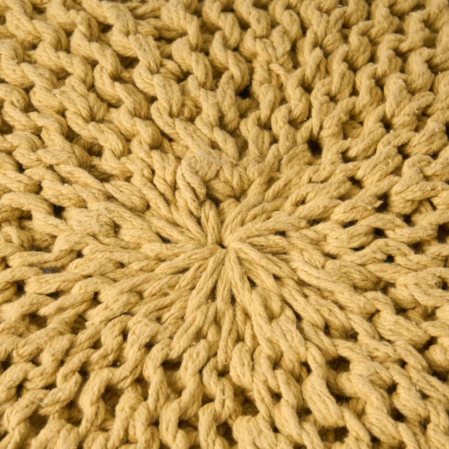 Closeup of thick mustard yellow knitted yarn texture perfect for cozy blankets