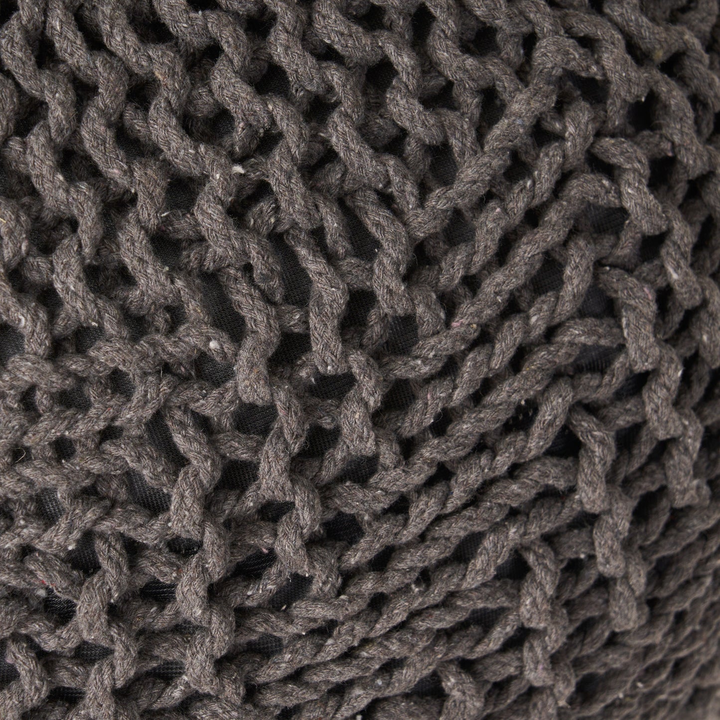 Closeup of a chunky knit grey yarn throw pillow showcasing its textured weave