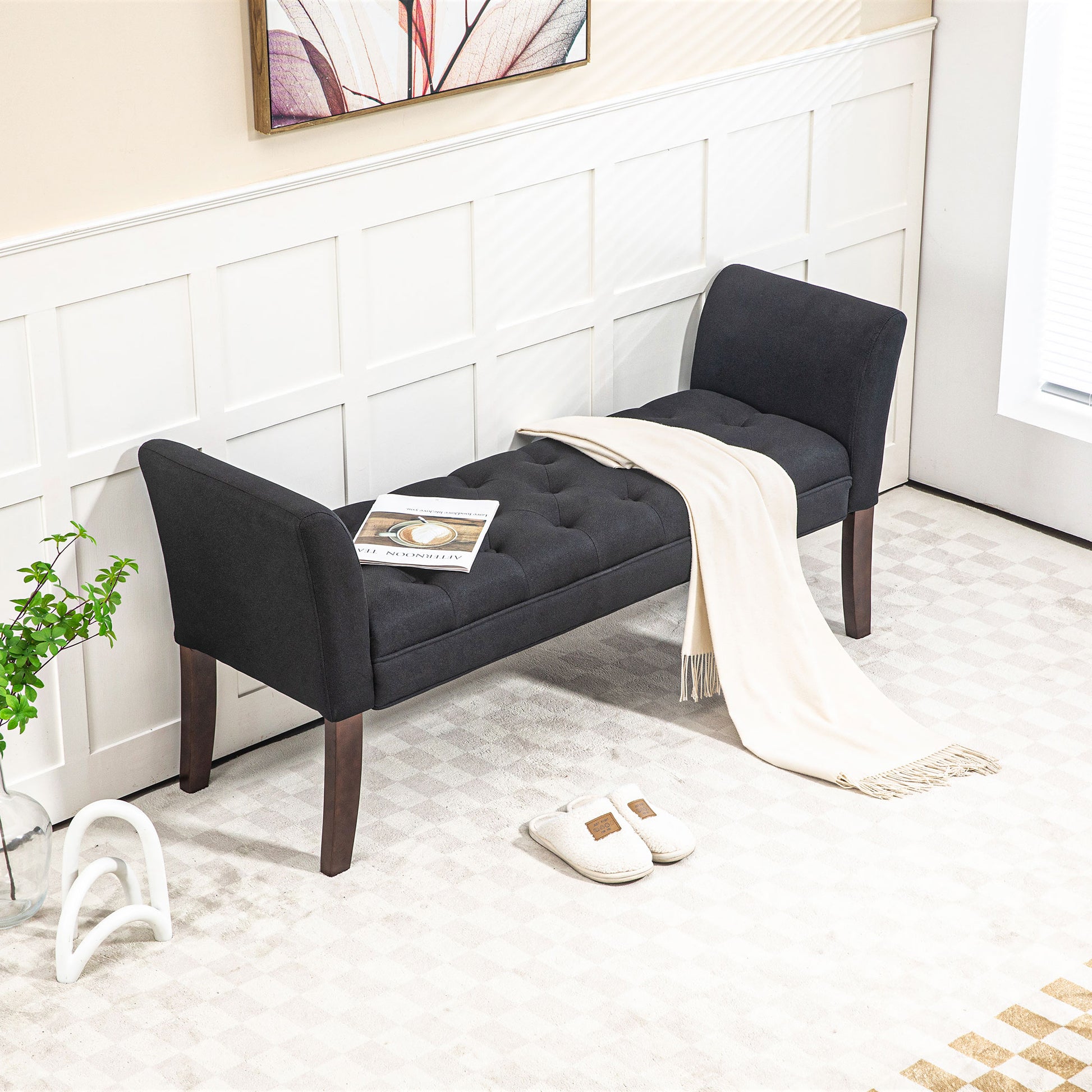 Dark gray upholstered bench with tufted seat and wooden legs