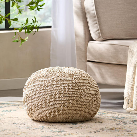 Beige knitted ottoman with textured weave a bohemian accent for living rooms