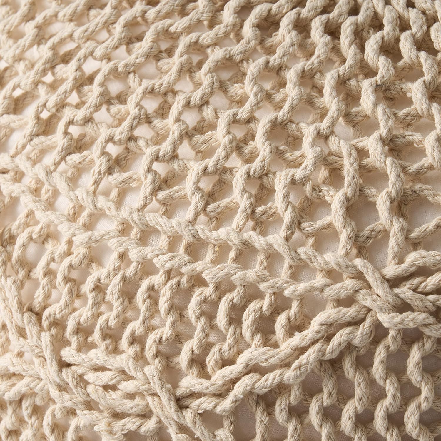 Closeup of thick creamcolored macrame rope detail on a textured surface perfect for boho decor