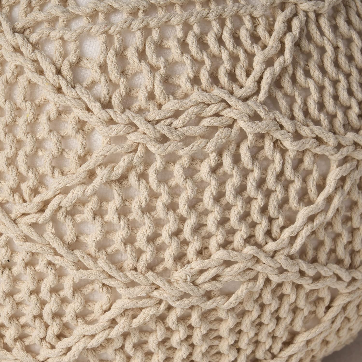 Closeup of beige macrame weave detail on textured fabric for home decor