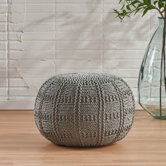 Textured gray knit pouf with intricate stitch pattern perfect for footrest or accent seating