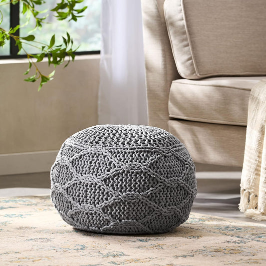 Round grey knitted pouf with a diamond pattern perfect for extra seating