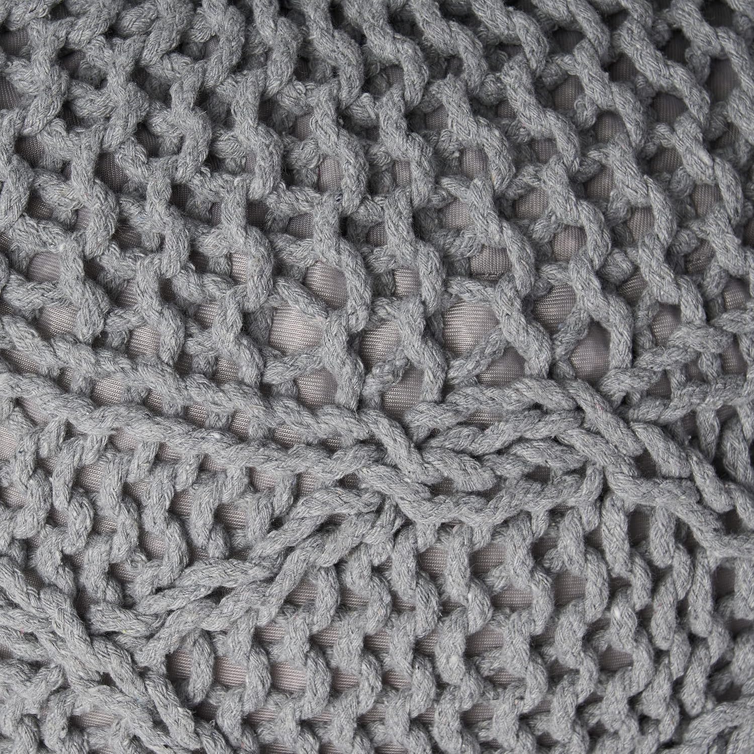Closeup of a chunky knit grey pouf with a macramestyle weave and visible texture