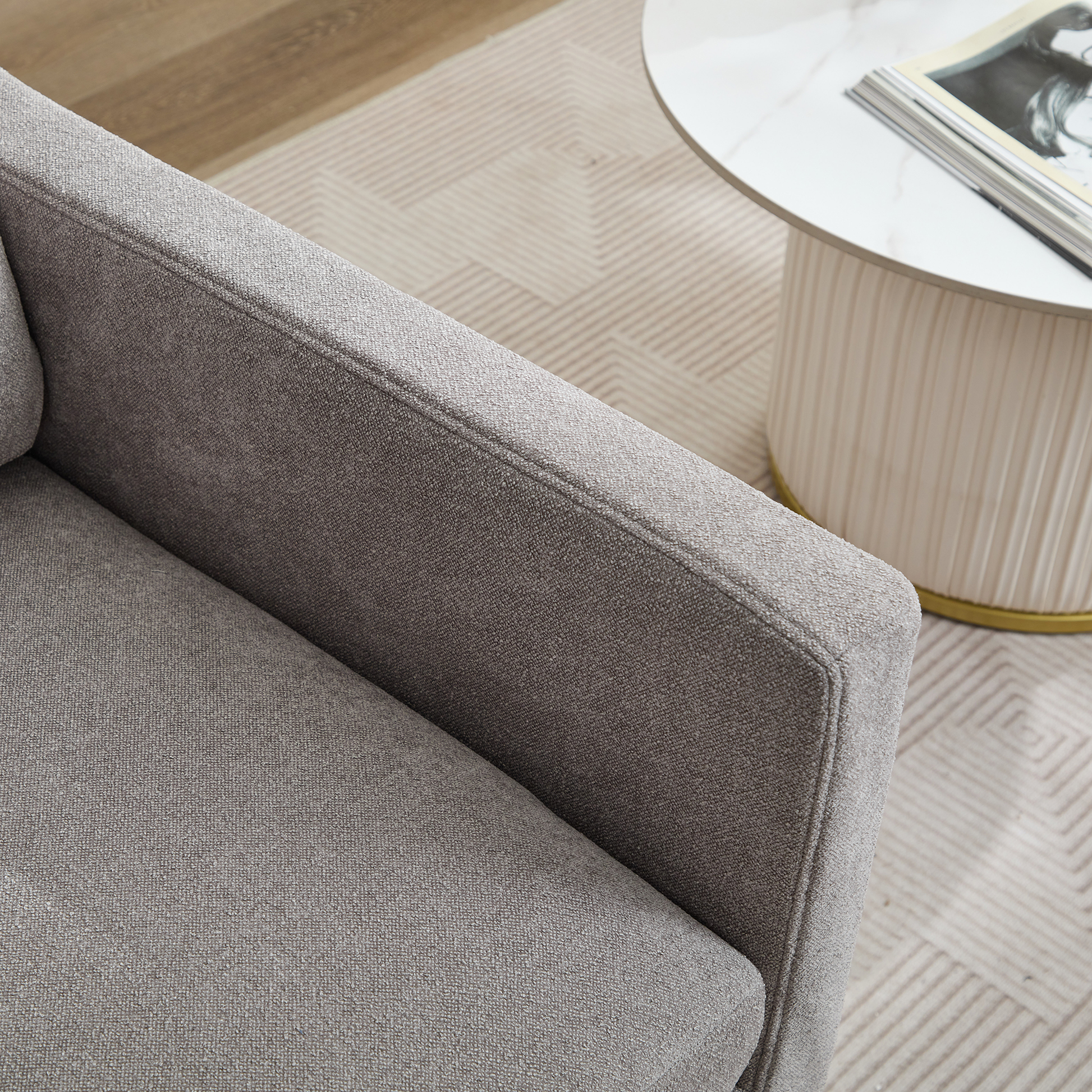 Closeup of textured grey fabric armrest on a modern armchair perfect for living rooms