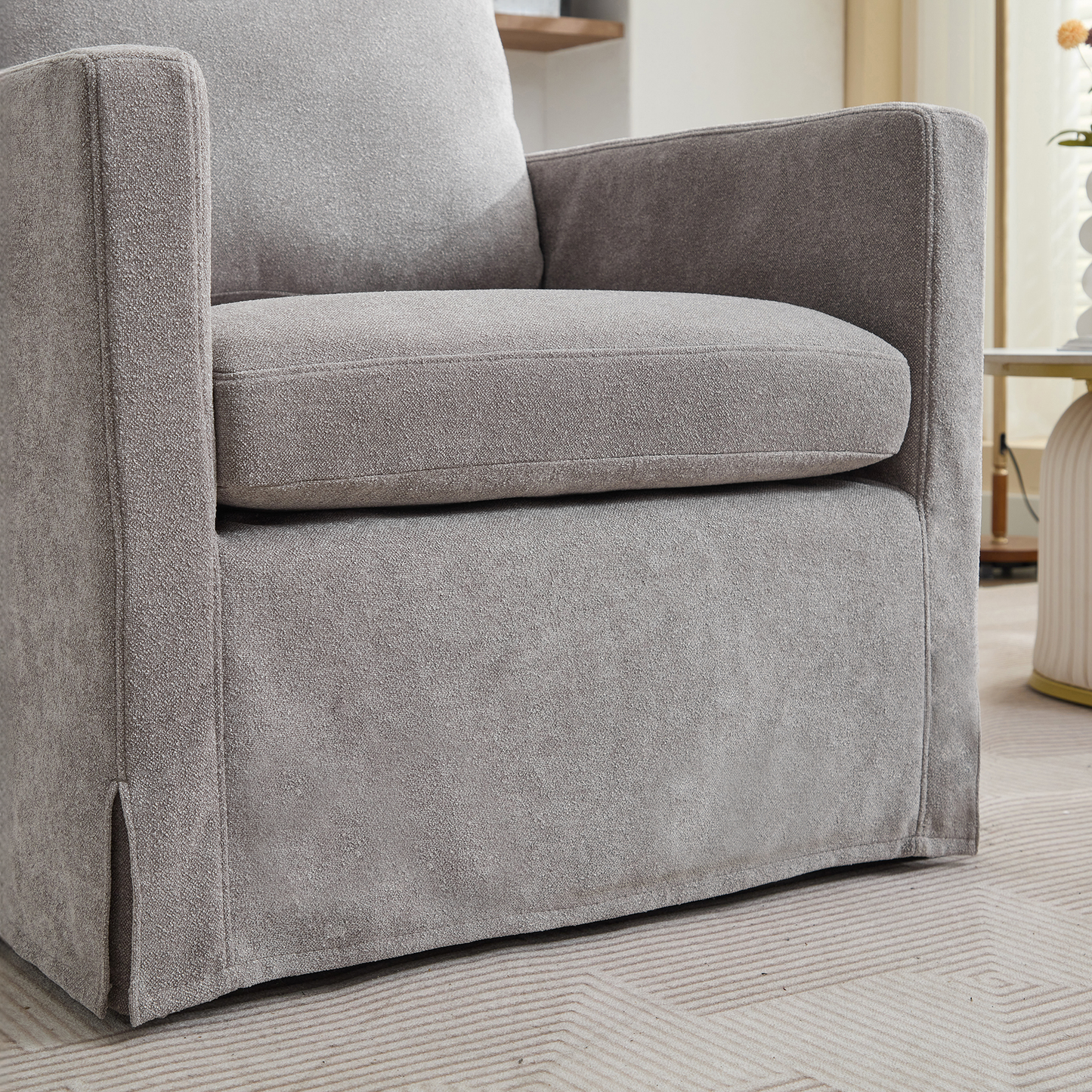 Closeup of plush grey fabric armchair with clean lines and comfortable seat