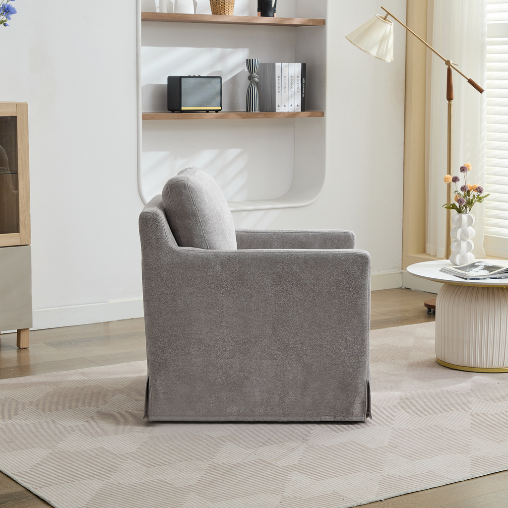 Gray upholstered armchair with plush cushion and modern design