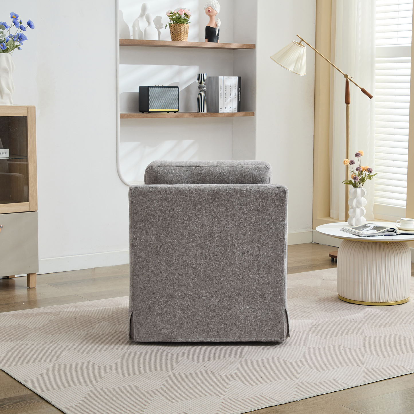 Grey upholstered accent chair with plush cushioning ideal for modern living rooms