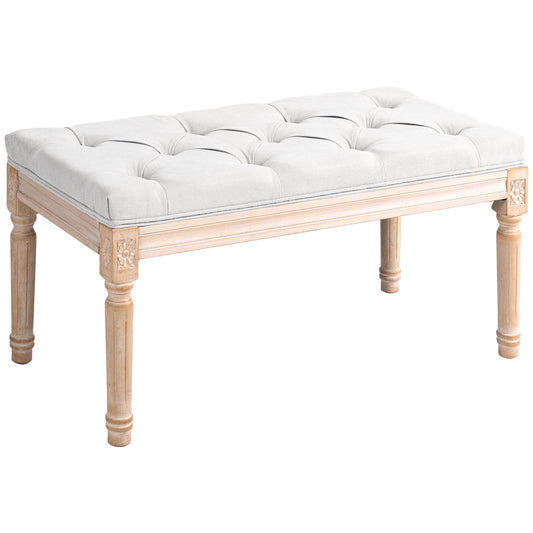 Tufted upholstered bench with light wood frame and carved details