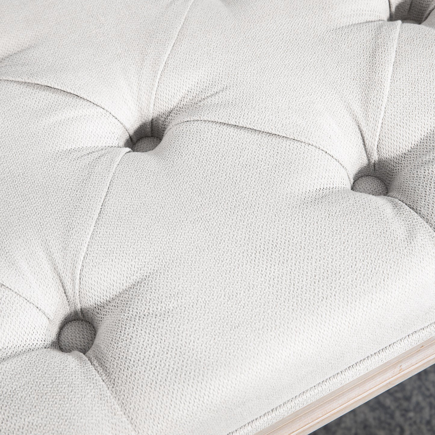 Tufted white faux leather ottoman with diamond stitching