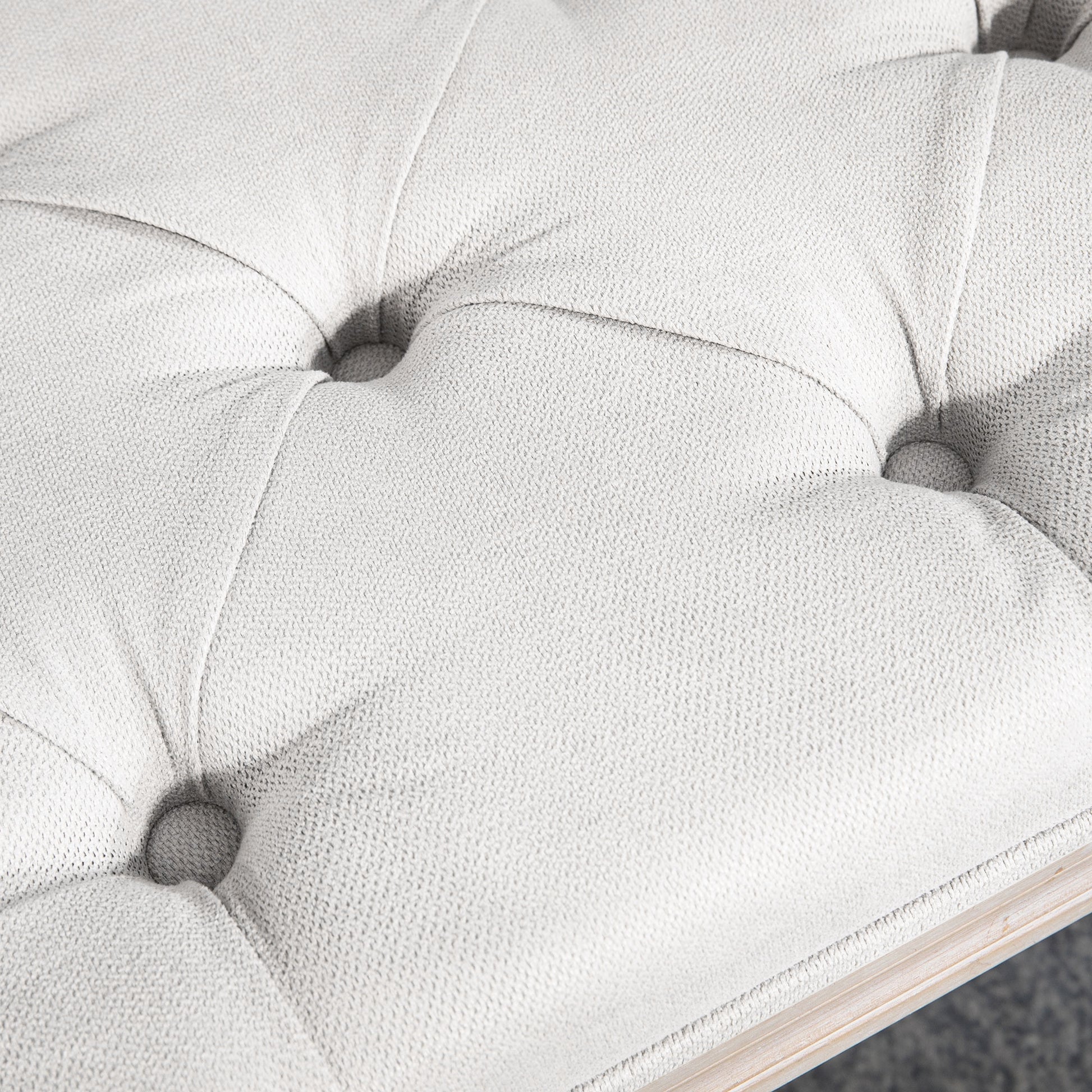 Tufted white faux leather ottoman with diamond stitching