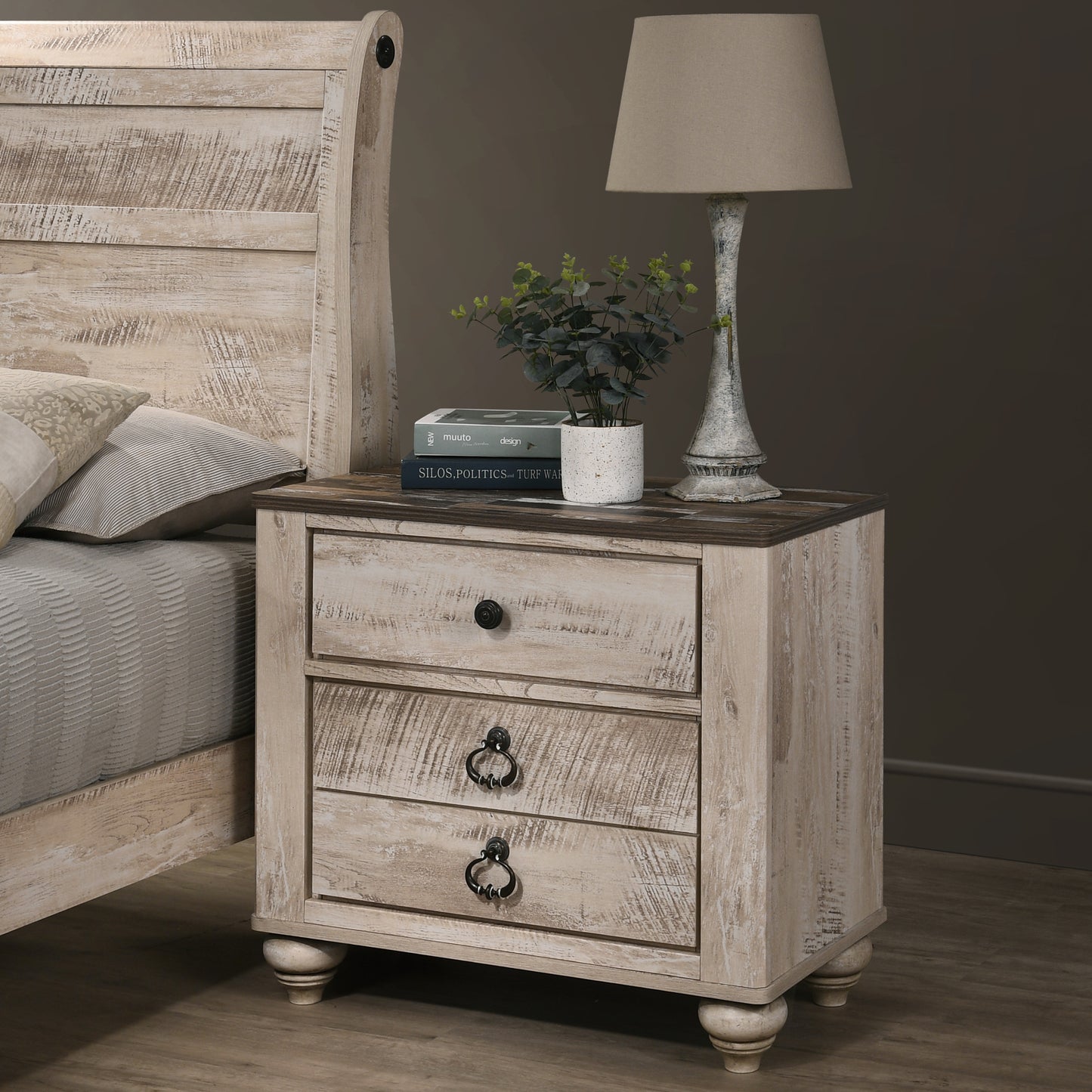 Whitewashed wood nightstand with three drawers and antique brass hardware