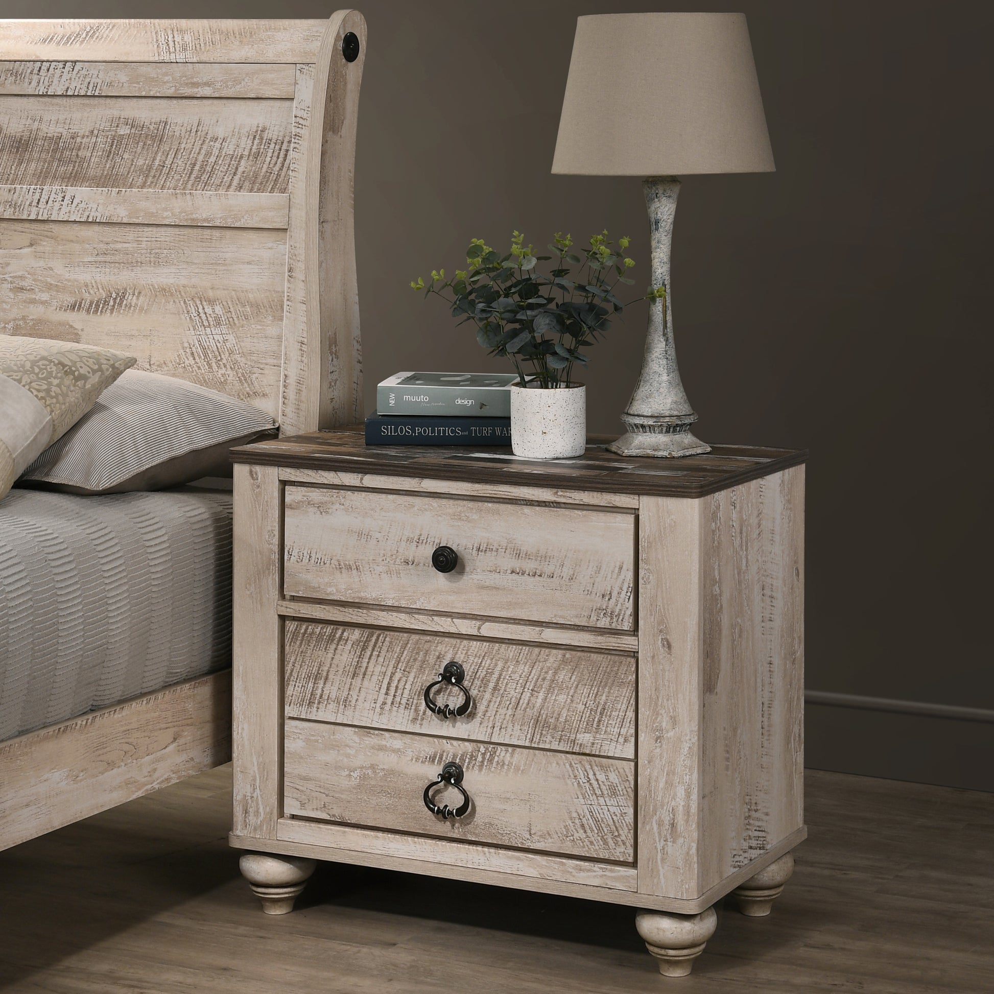 Whitewashed wood nightstand with three drawers and antique brass hardware