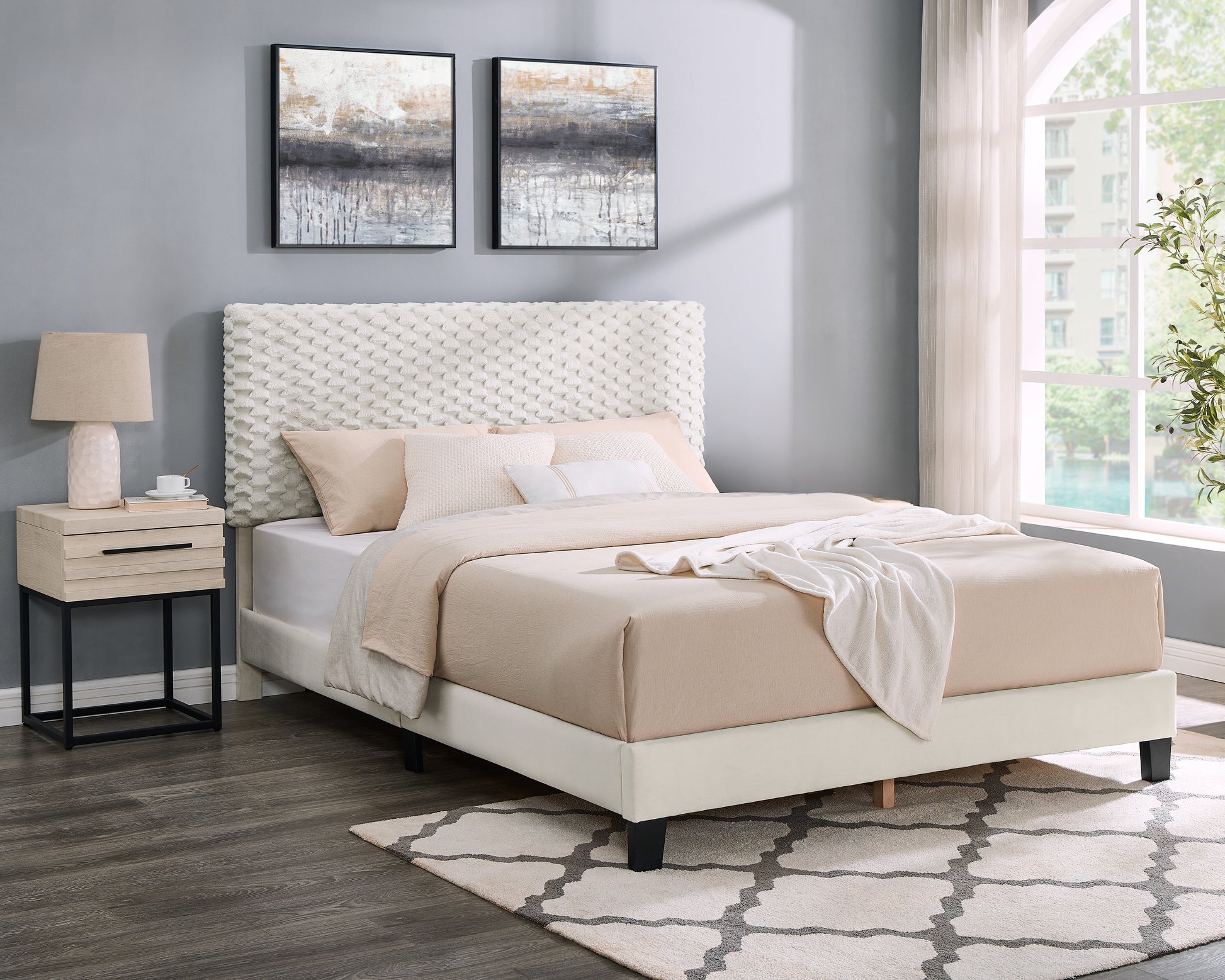 Modern upholstered bed with textured white headboard and cream bedding