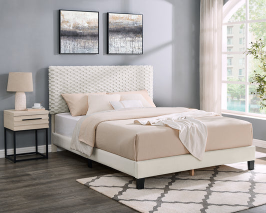 Modern upholstered bed with textured white headboard and cream bedding