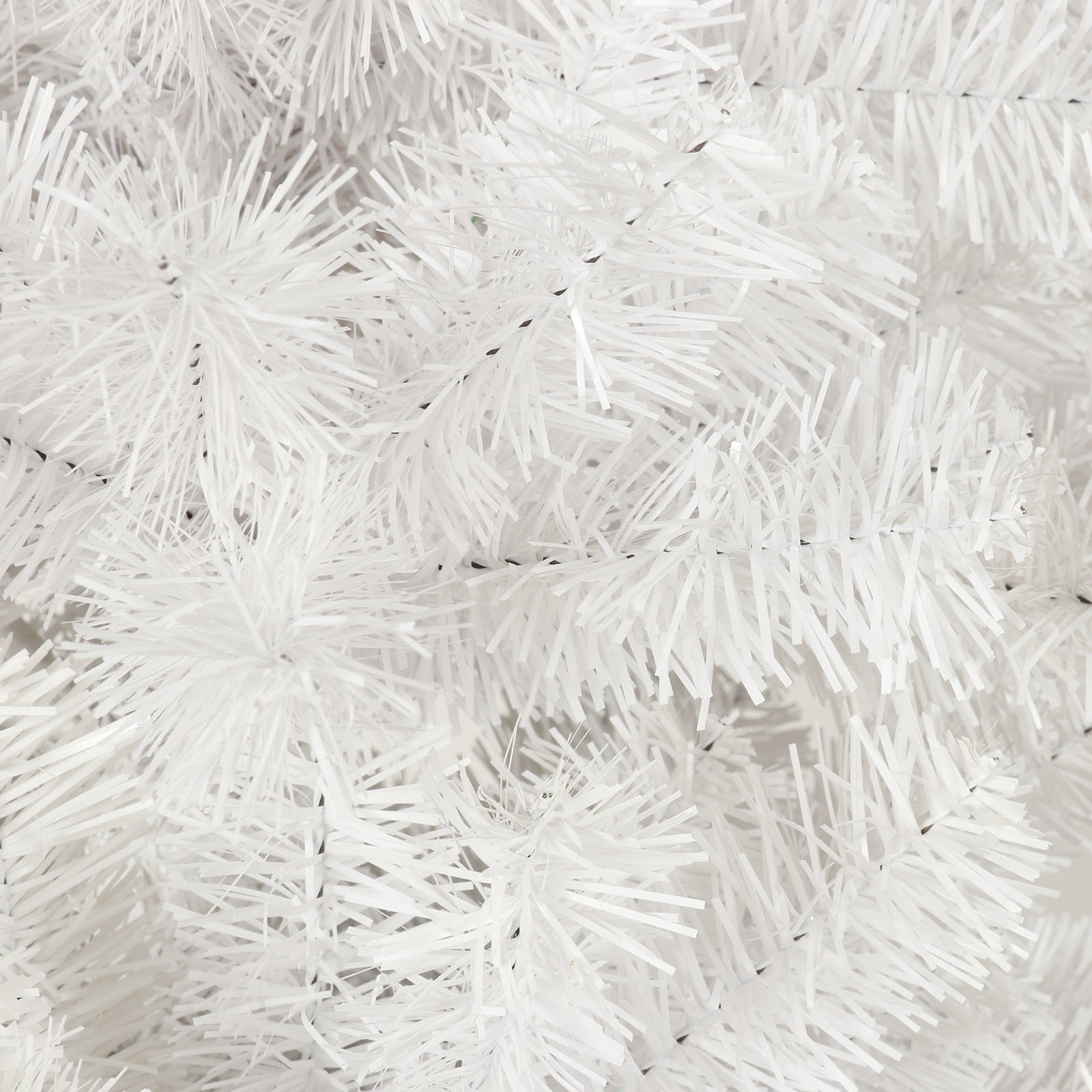Closeup of a fluffy white artificial Christmas tree branch perfect for festive decor