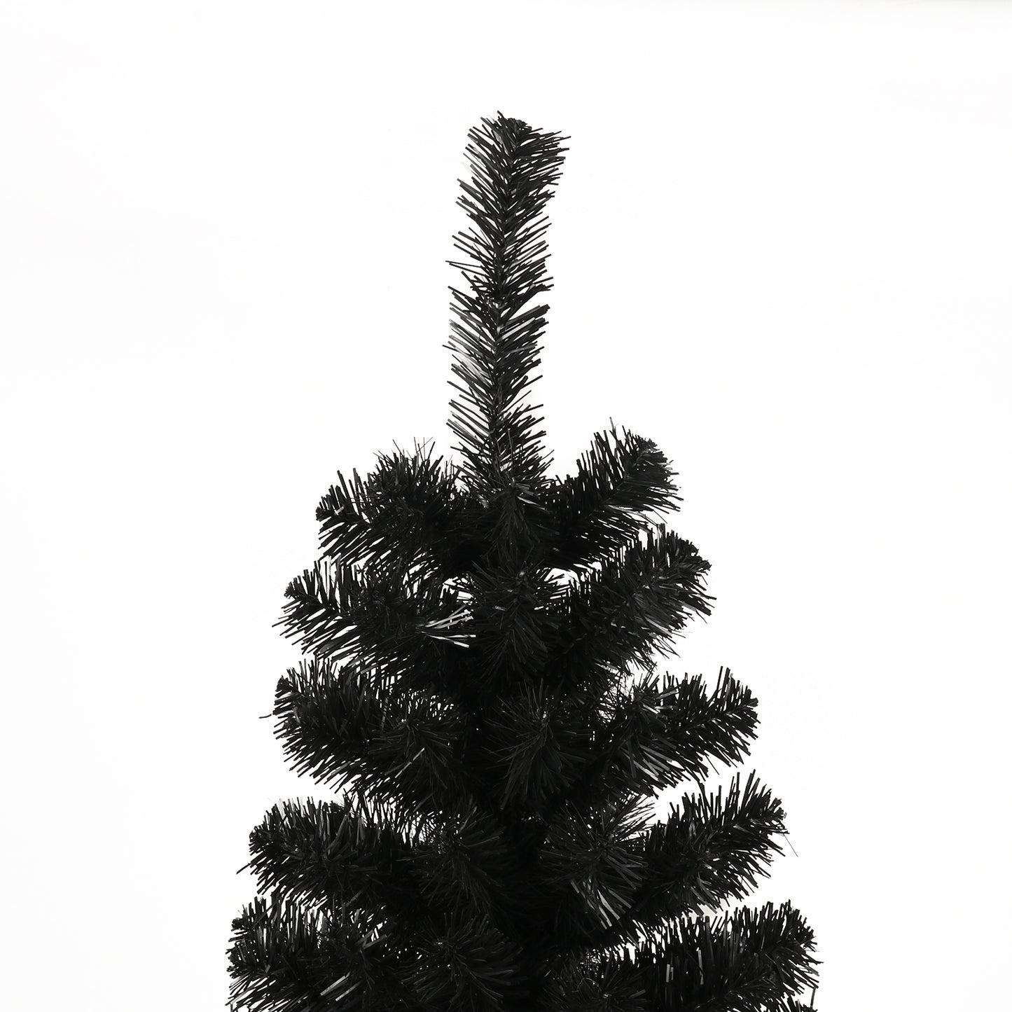 Closeup of a flocked black artificial Christmas tree branch tips against white background