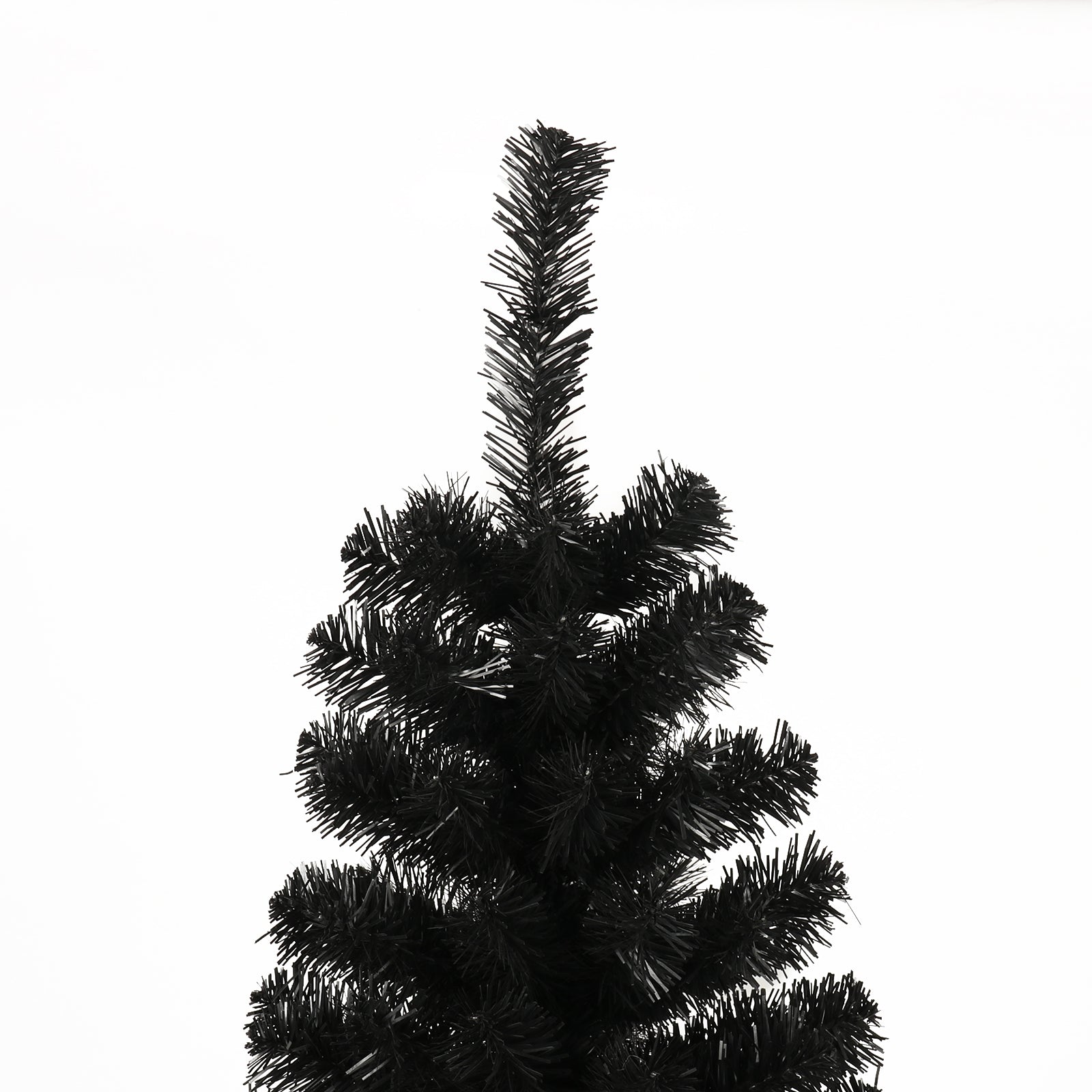 Closeup of a flocked black artificial Christmas tree branch tips against white background
