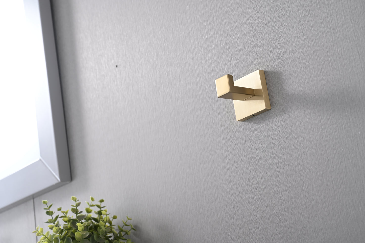 Modern brass wall hook with a clean minimalist design for bathroom accessories