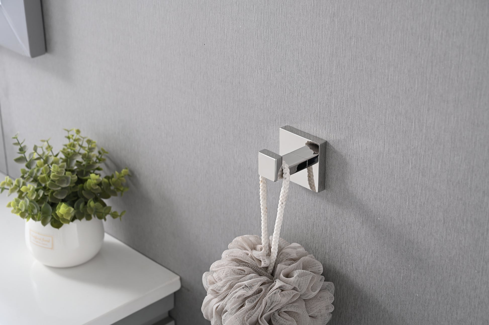 Polished chrome square bath hook holding a white rope loofah