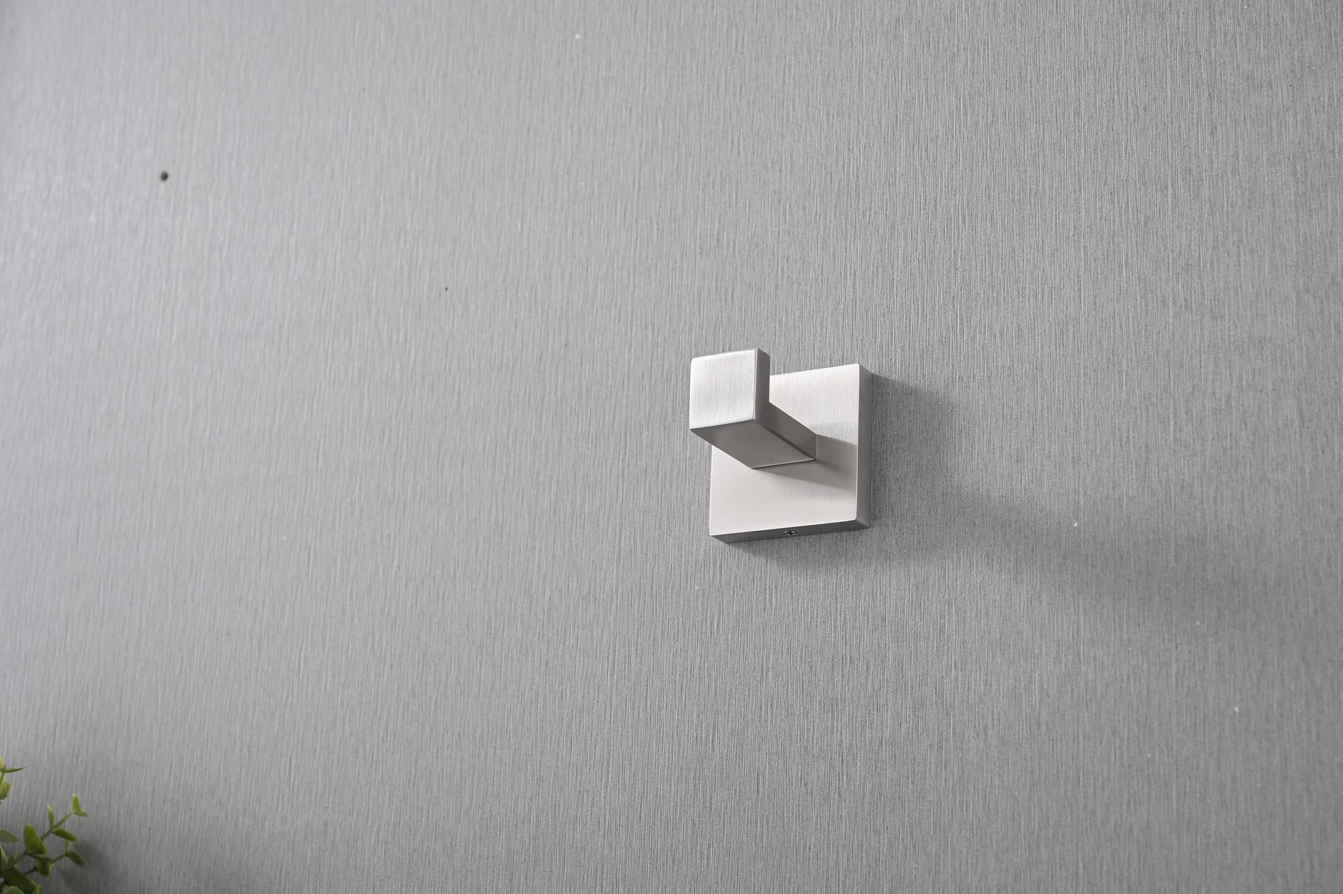 Modern brushed nickel wall hook with a sleek geometric design for entryways or bathrooms