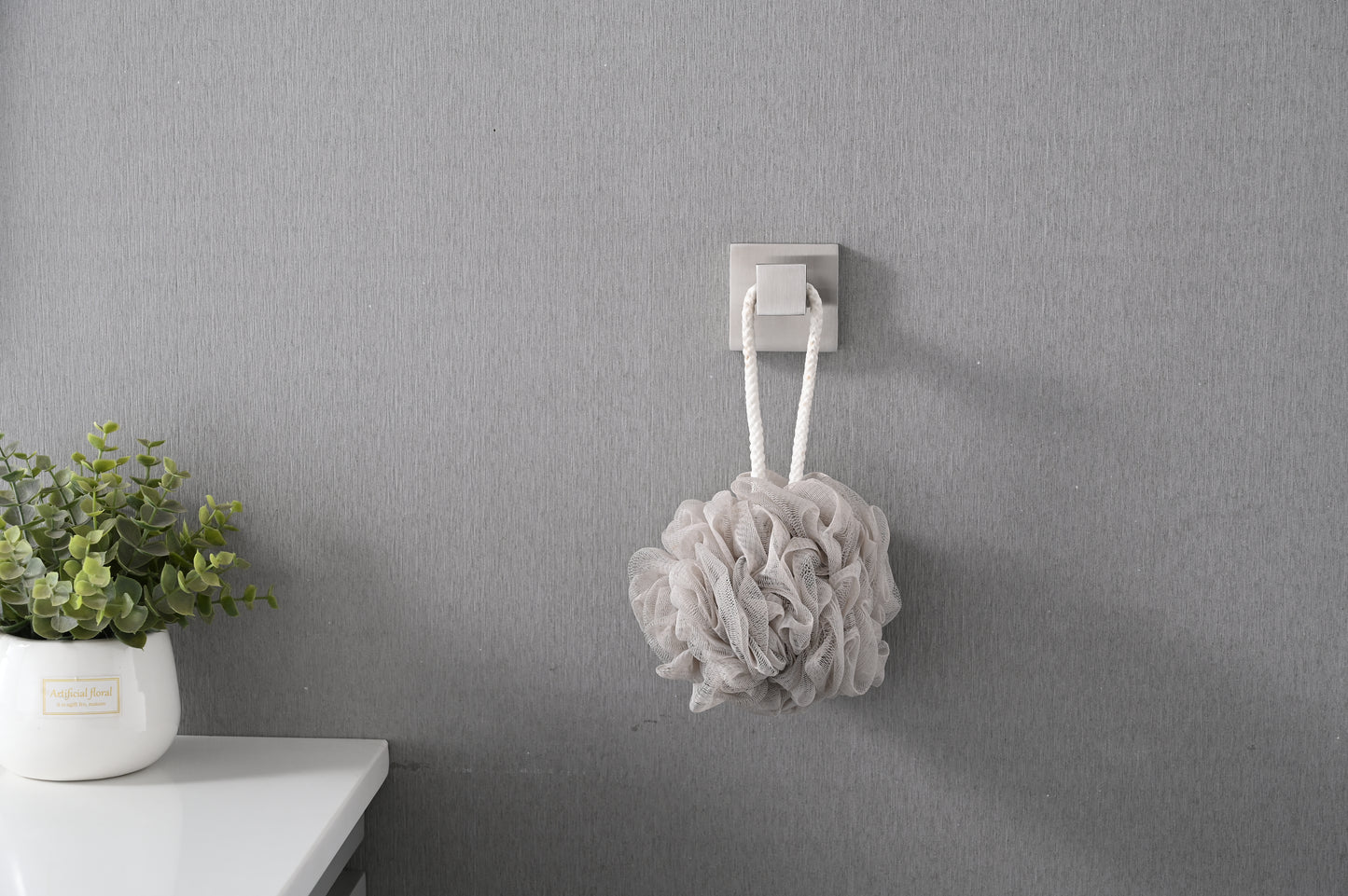 Soft plush grey loofah with a braided cord for hanging ideal for exfoliation