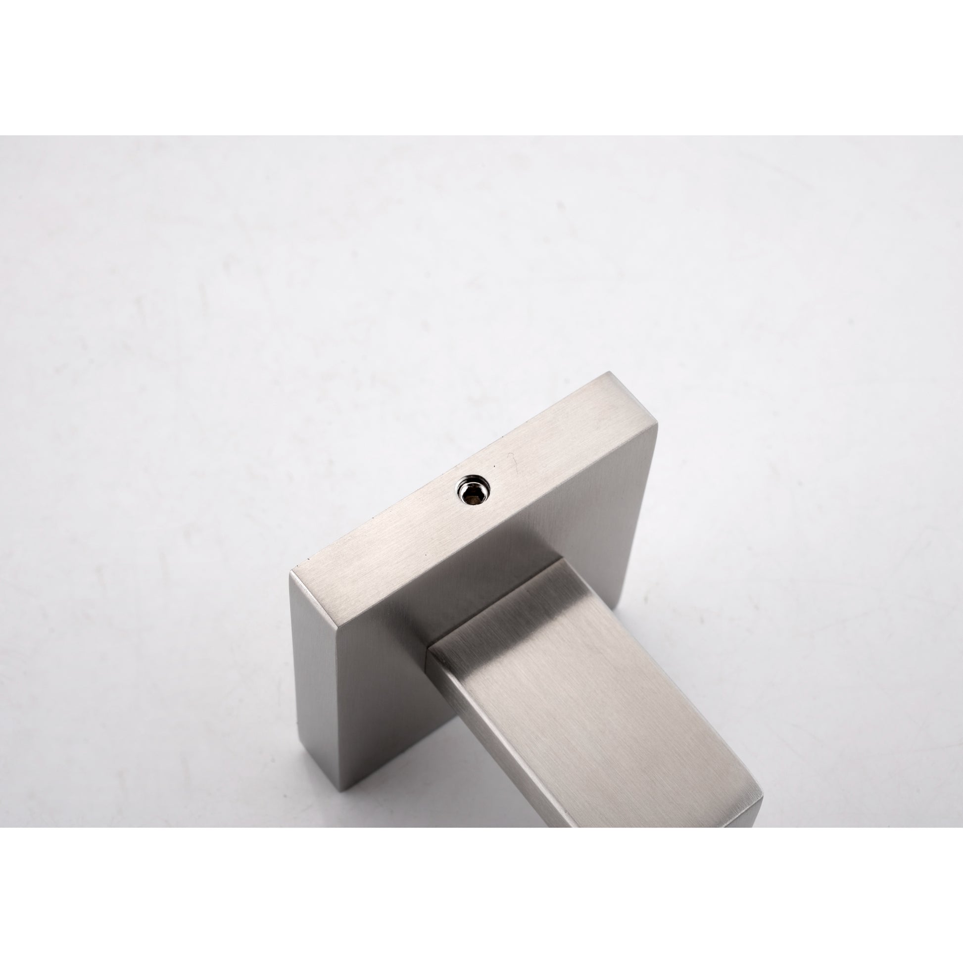 Brushed nickel modern door handle with a minimalist square base