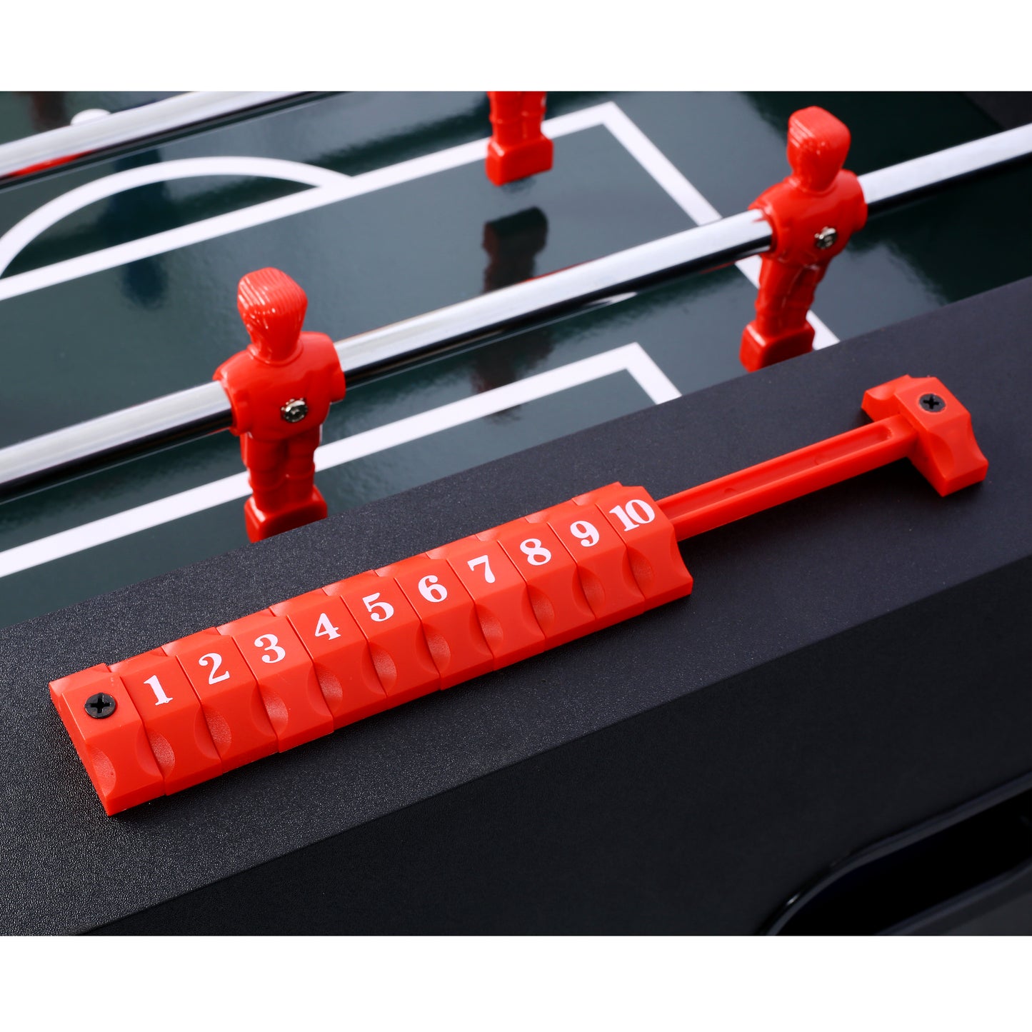 Red plastic foosball men on a metallic rod for a table football game