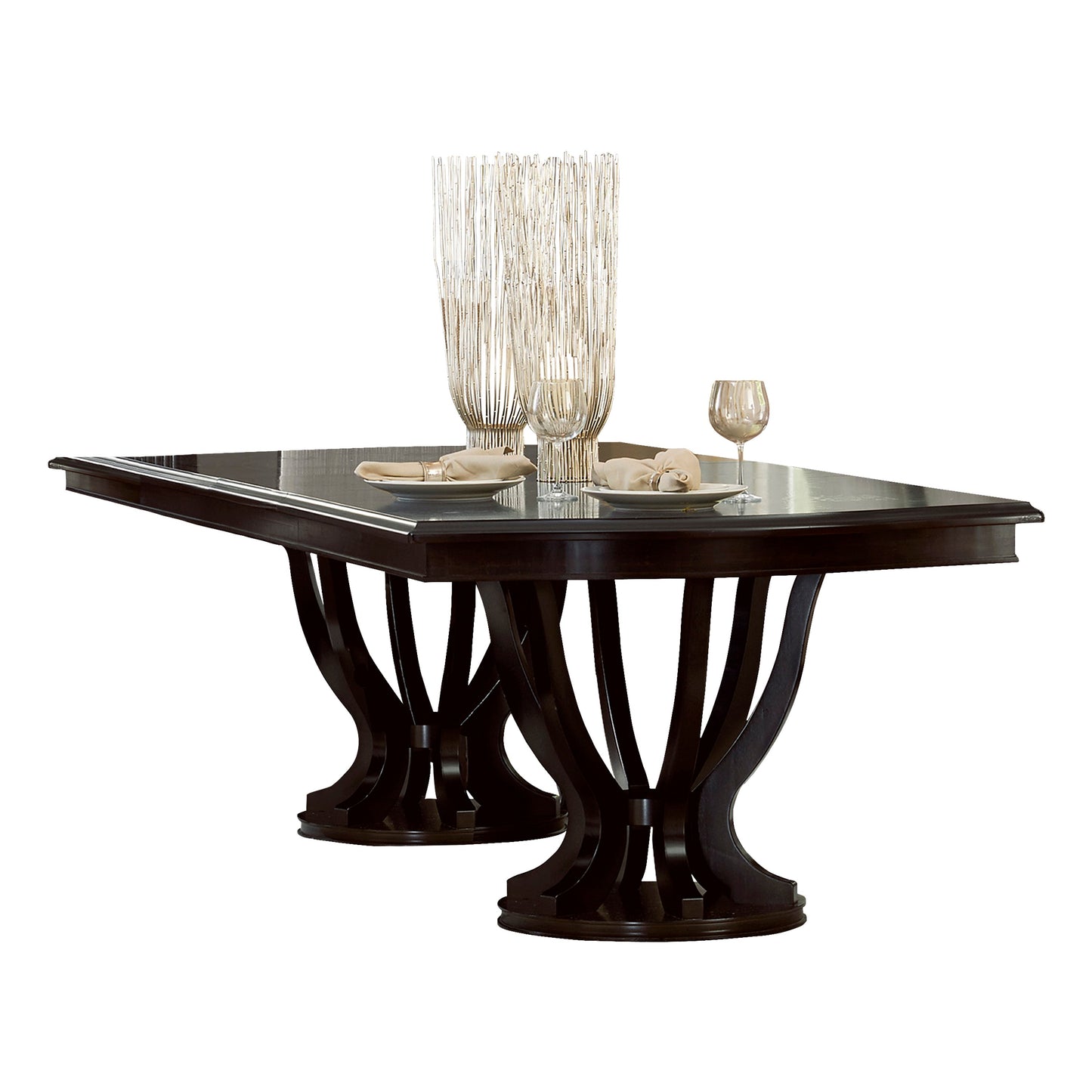 Dark wood dining table with sculpted pedestal bases and place settings