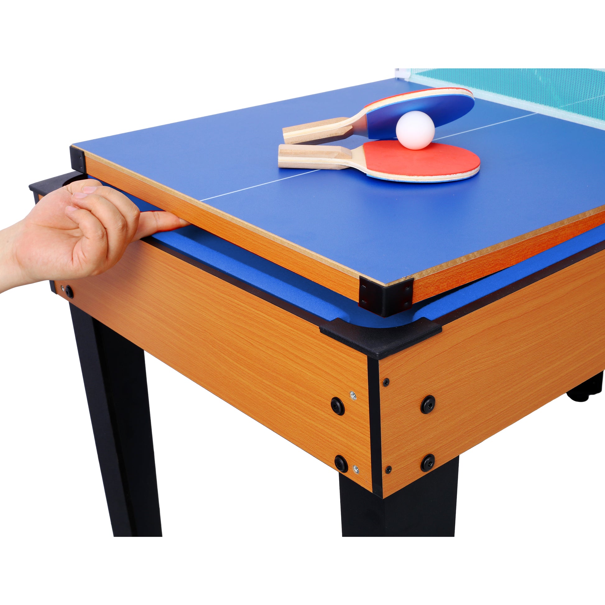 Two ping pong paddles and a ball on a blue table tennis surface