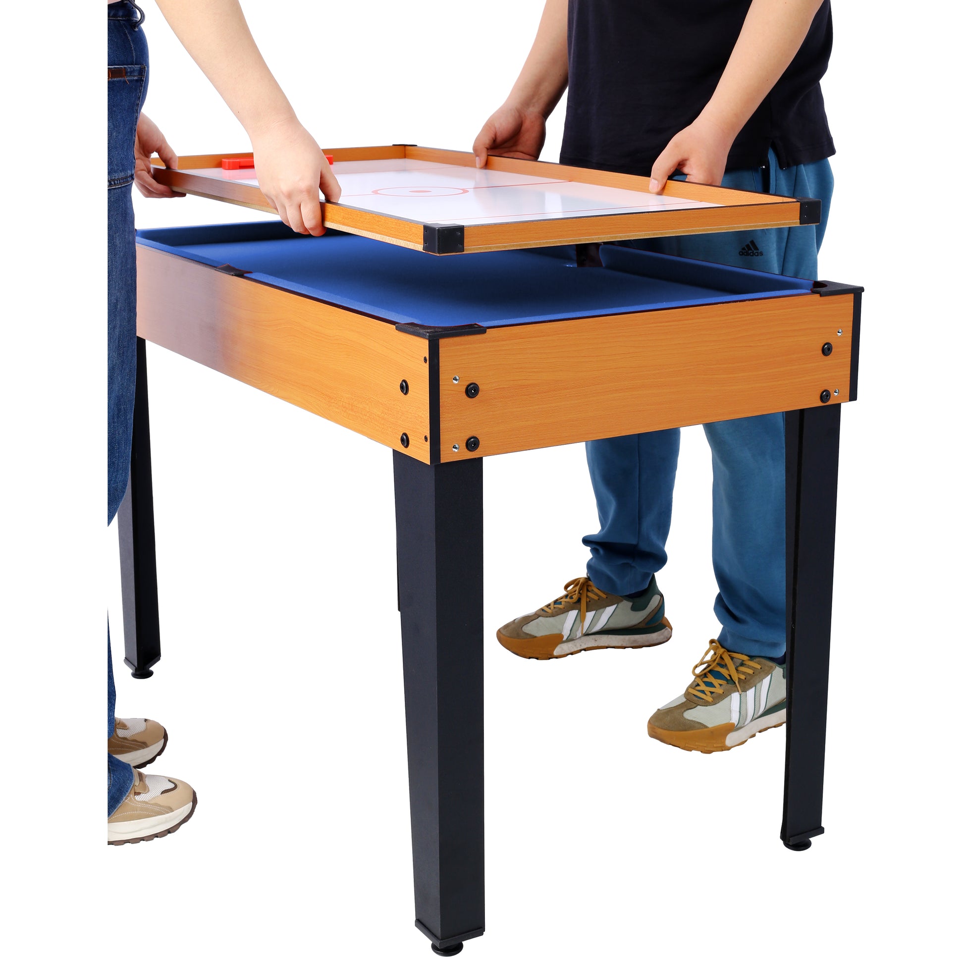 Wooden framed air hockey table with blue felt set up for play
