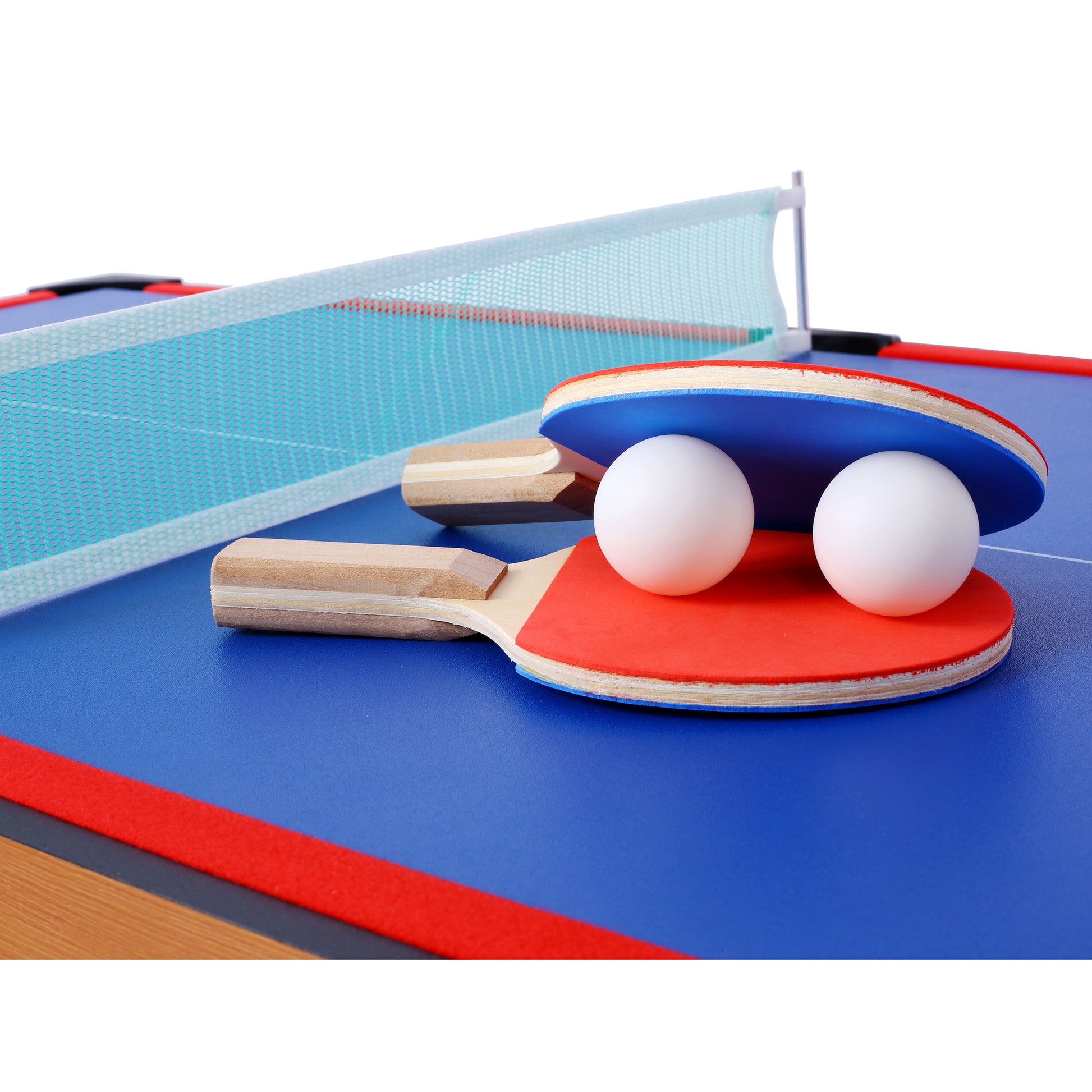 Blue ping pong paddle with red grip and two white ping pong balls on table