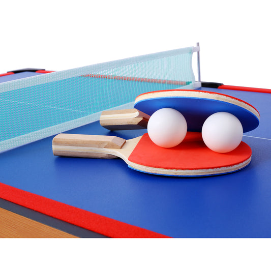 Blue ping pong paddle with red grip and two white ping pong balls on table