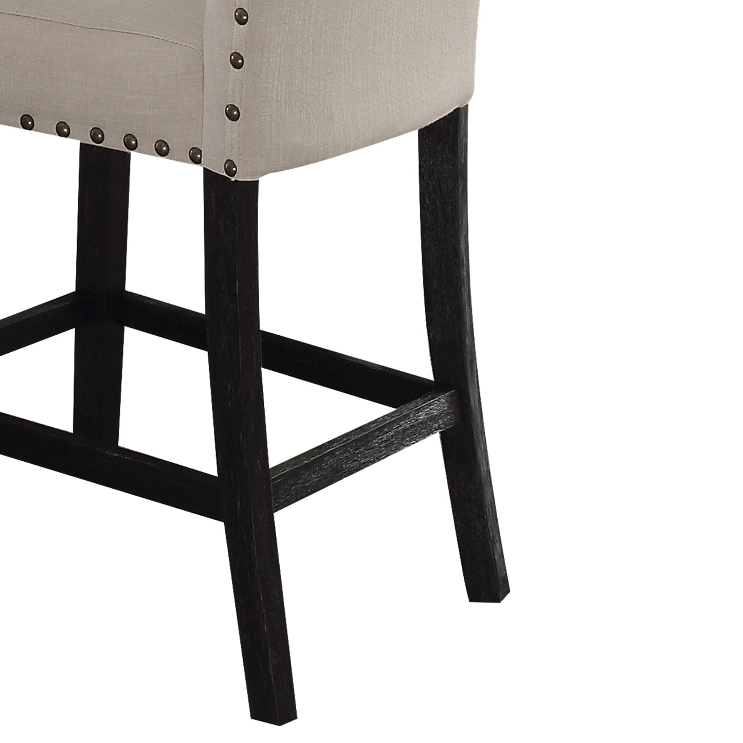 Close up of beige linen upholstered bar stool with nailhead trim and dark wood legs