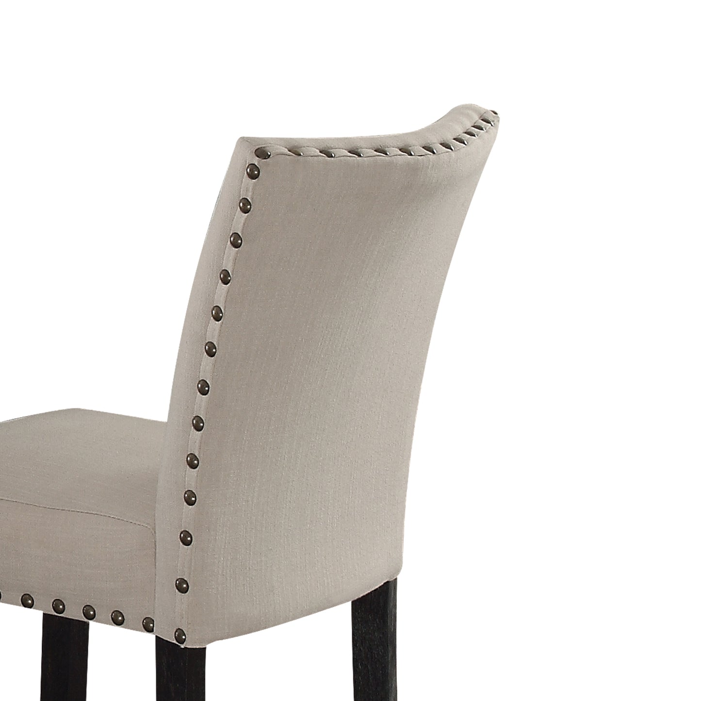 Closeup of a light gray fabric armchair back with decorative nailhead trim and dark wooden legs