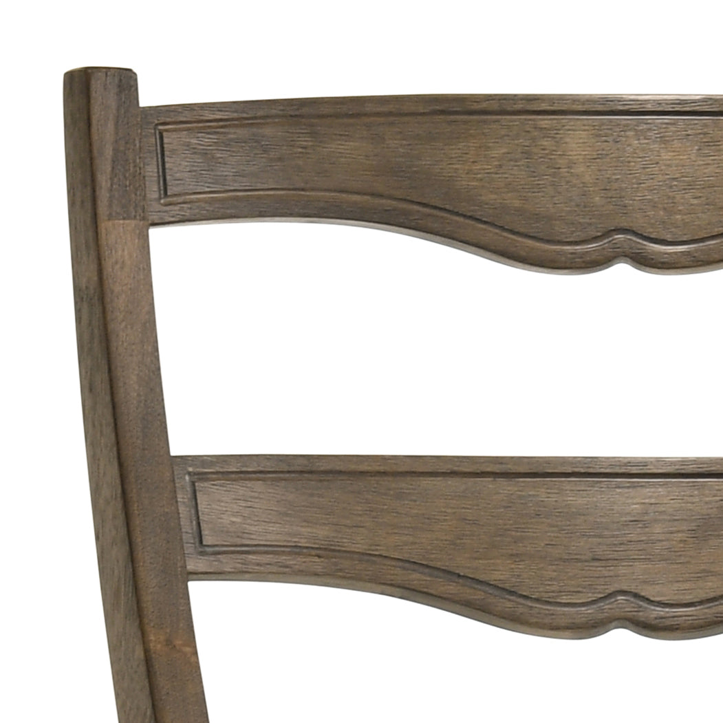 Closeup of distressed oak dining chair back with curved silhouette