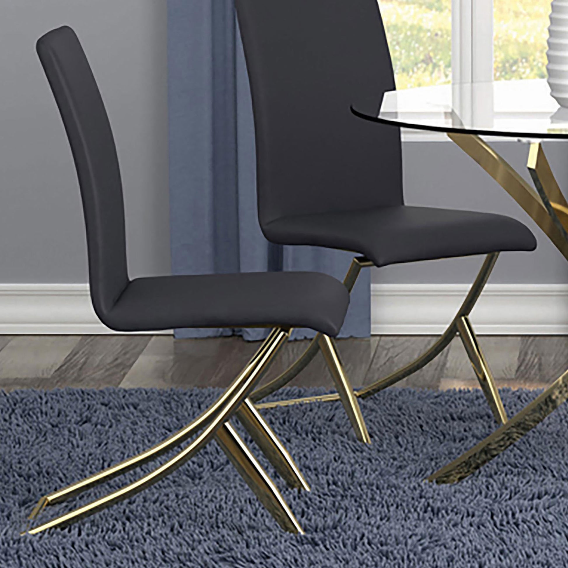 Dark gray faux leather dining chair with polished gold legs