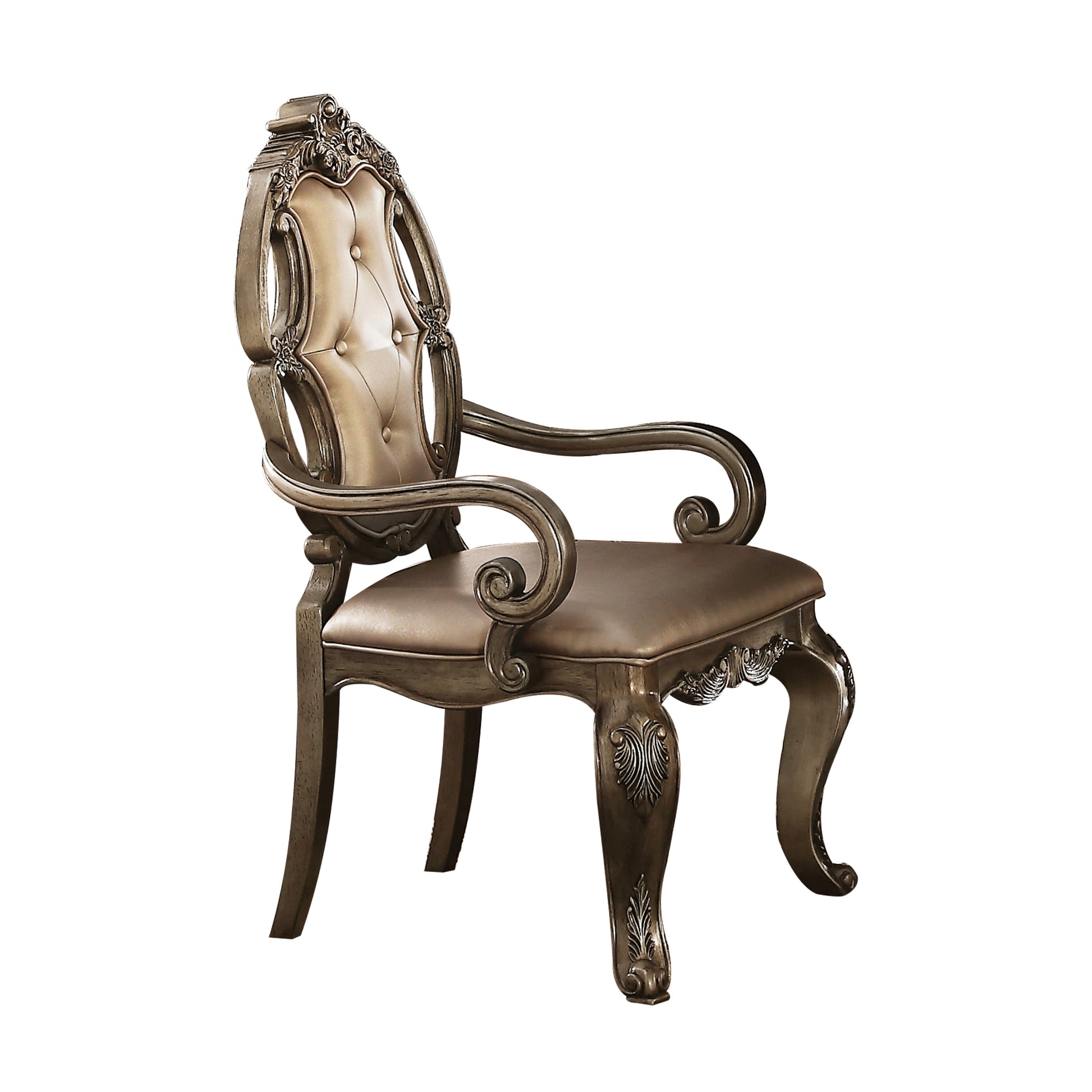 Ornate carved armchair with tufted champagne fabric seat and backrest